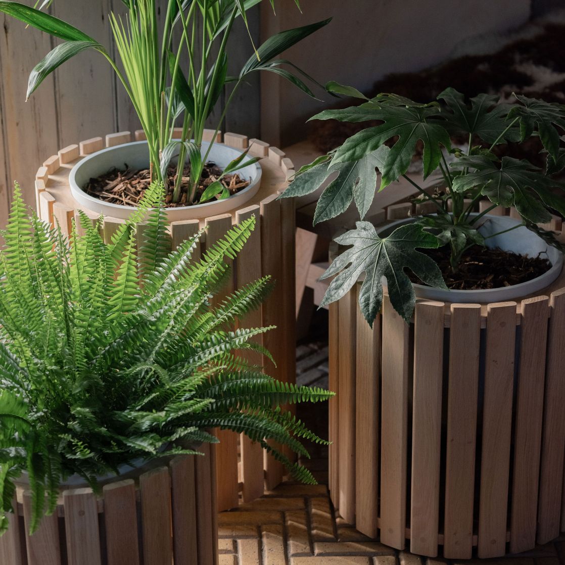 3 wooden planters on a tile floor